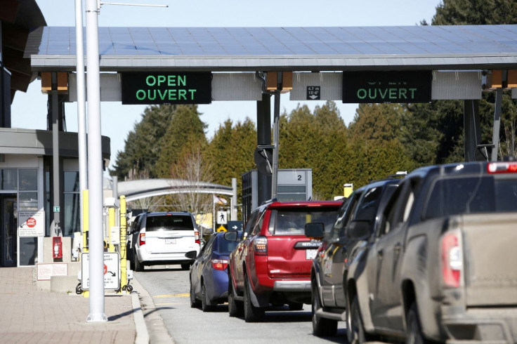 Drivers wait to cross through Canadian customs at the Canada-US border near the Peace Arch Provincial Park in Surrey, British Columbia, Canada. Canada March 16, 2020.  
