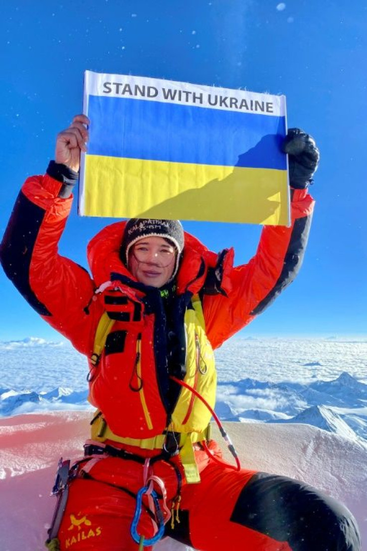 On the roof of the world, Antonina Samoilova held up a blue and yellow panel emblazoned 'Stand With Ukraine' while her father and brother were serving in the army