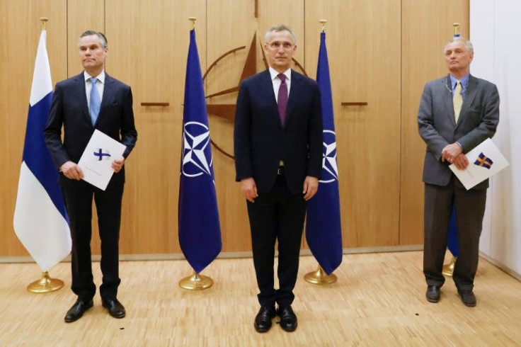 (l to r) Finland's Ambassador to NATO Klaus Korhonen, NATO Secretary-General Jens Stoltenberg and Sweden's Ambassador to NATO Axel Wernhoff in Brussels on Wednesday