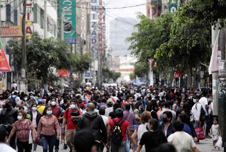 People walk in a crowded street as new cases of the coronavirus disease (COVID-19), driven by the Omicron variant, are surging, in Lima, Peru January 12, 2022. Picture taken January 12, 2022.