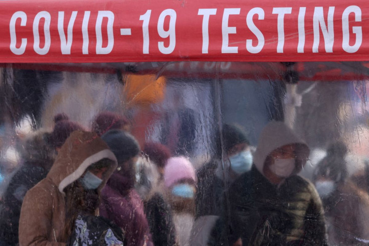 People queue to be tested for COVID-19 in Times Square, as the Omicron coronavirus variant continues to spread in Manhattan, New York City, U.S., December 20, 2021. 