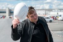 Tesla CEO Elon Musk tips his hard hat