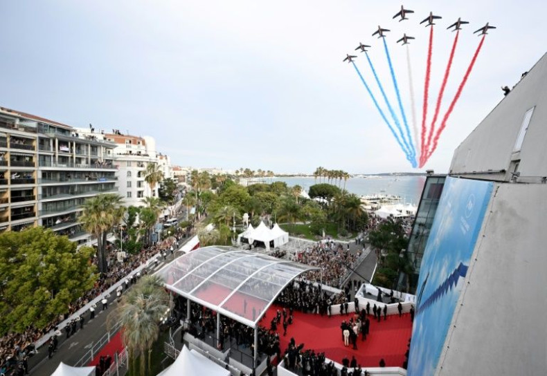 The French national air display team streak over the red carpet