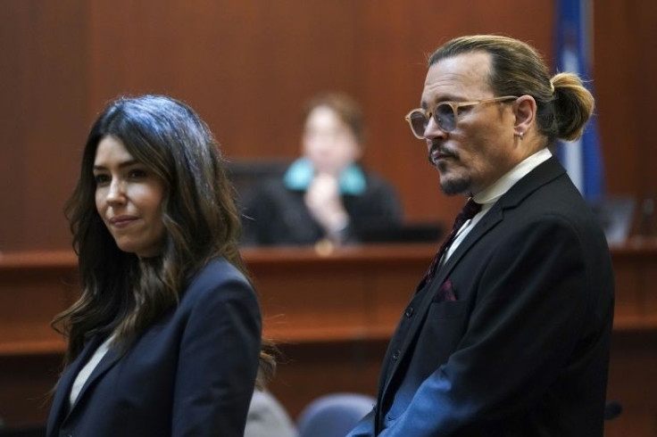 US actor Johnny Depp stands next to his lawyer Camille Vasquez after a break in the defamation case he filed against ex-wife Amber Heard