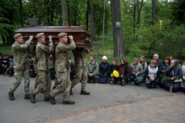 Members of the Honour Guard carry a coffin with a body of Denys Antipov, Ukrainian serviceman recently killed in a fight with Russian troops, in Kyiv, Ukraine May 18, 2022.  