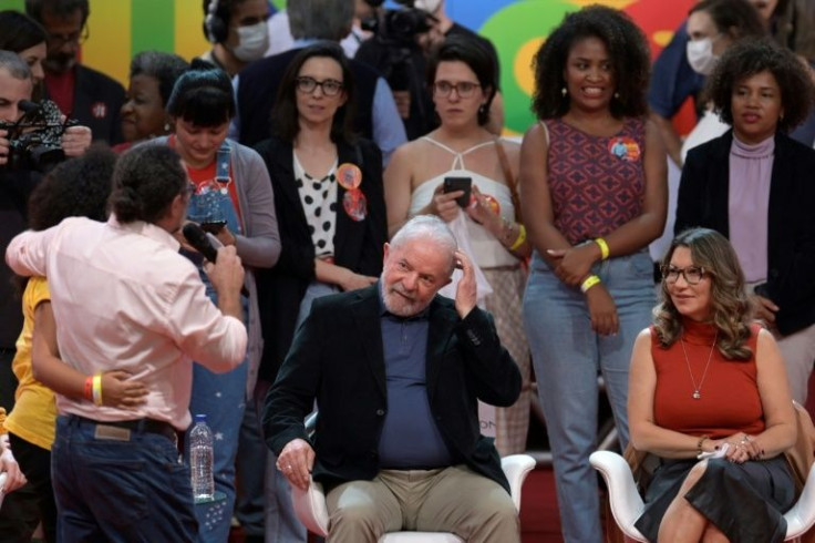 Brazil's presidential hopeful Lula (centre) sitting beside his fiancee Rosangela da Silva at an event in Belo Horizonte in May, 2022