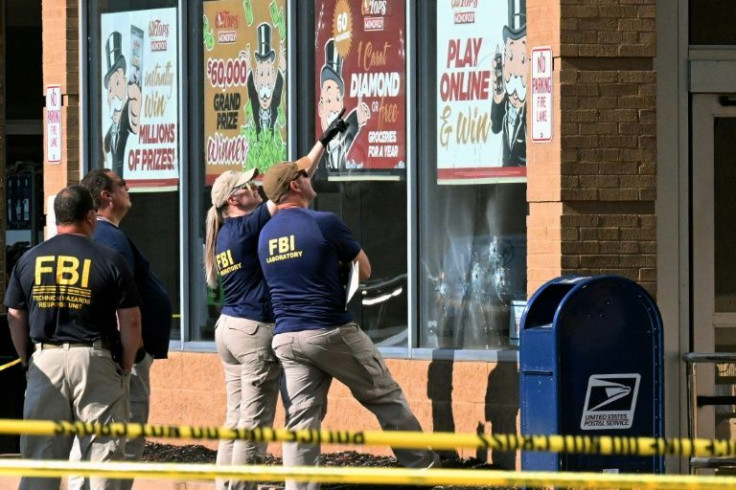 FBI agents look at bullet impacts in the Buffalo, New York grocery store where a gunman livestreamed himself shooting 13 people -- 10 of whom died