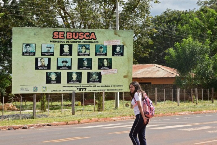 Posters with the photos of wanted Paraguayan People's Army (EPP) members are dotted around Concepcion