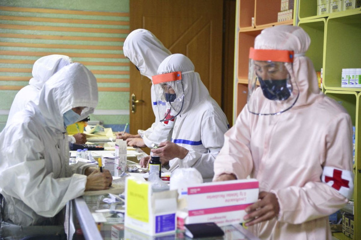 Members of the North Korean army supply medicines to residents at a pharmacy, amid growing fears over the spread of the coronavirus disease (COVID-19), in Pyongyang, North Korea, in this photo released by Kyodo on May 18, 2022. Kyodo/via REUTERS 