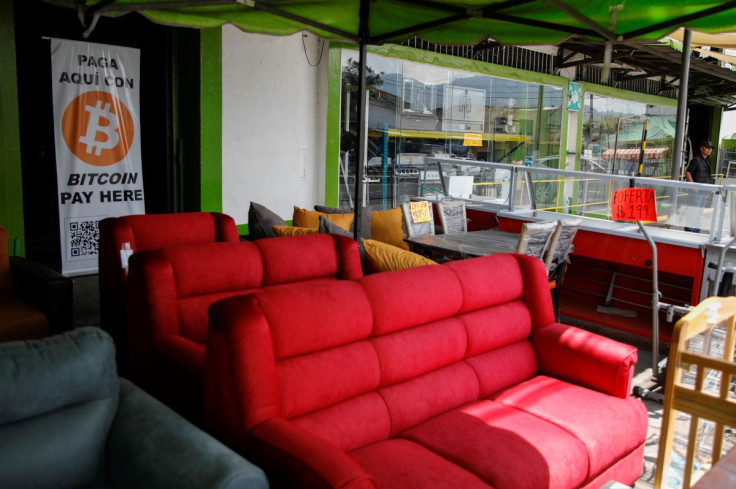 FILE PHOTO - A sign reading âPay with Bitcoin hereâ is set in a furniture store in San Salvador, El Salvador March 10, 2022. 