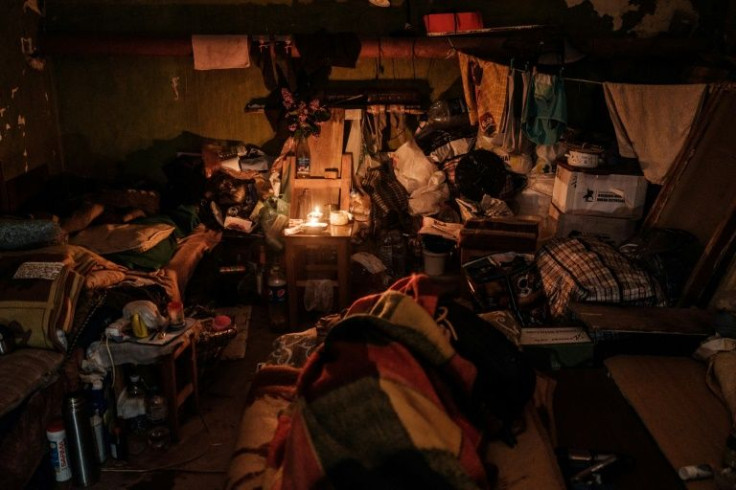 Oil lamps offer the only light in a basement where 27 Severodonetsk residents have lived without power or running water for a month