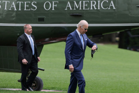 U.S. President Joe Biden checks his watch after arriving at the White House following an interagency briefing on hurricane preparedness at Joint Base Andrews, in Washington, U.S., May 18, 2022. 