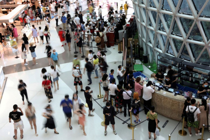 People wearing face masks following the coronavirus disease (COVID-19) outbreak shop at the Sanya International Duty-Free Shopping Complex in Sanya, Hainan province, China November 25, 2020. 