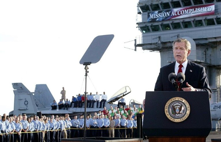 US President George W. Bush addresses his nation aboard the aircraft carrier USS Abraham Lincoln in the Gulf on May 1, 2003, in front of a banner reading "Mission Accomplished" --  a claim belied by years more of hard fighting in Iraq