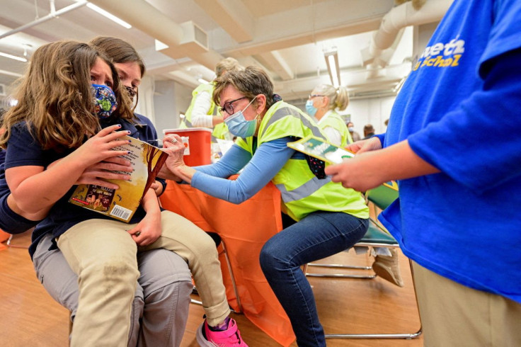 A child reacts while receiving a dose of the Pfizer-BioNTech coronavirus disease (COVID-19) vaccine at Smoketown Family Wellness Center in Louisville, Kentucky, U.S., November 8, 2021. 