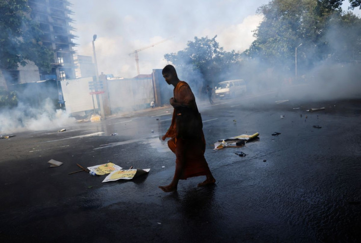 A protestor runs for cover after police used tear gas to disperse them during a protest organised by students near the Presidentâs House, amid the country's economic crisis, in Colombo, Sri Lanka, May 19, 2022. 