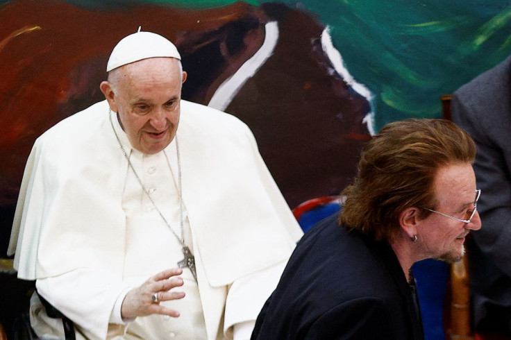 U2's frontman Bono walks next to Pope Francis during the inauguration of the 'Laudato Si' School in Rome, Italy, May 19, 2022. 