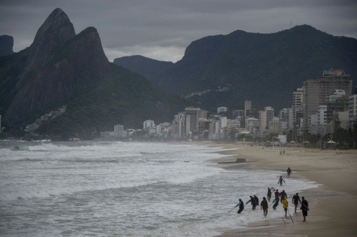 People are seen at Ipanema Beach in Rio de Janeiro, Brazil, on May 19, 2022, during an unusual cold snap affecting the center and south of the country, a month before the official start of winter