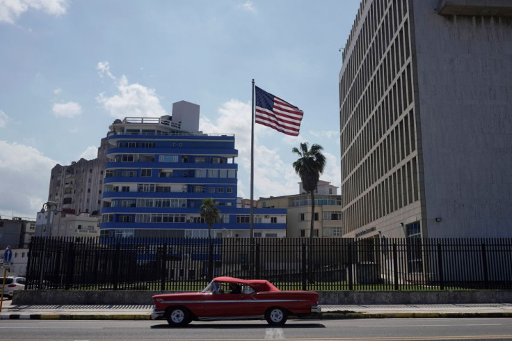 A vintage car used for touristic city tours passes by the U.S. Embassy in Havana, Cuba, November 10, 2021. Photo taken on November 10, 2021.