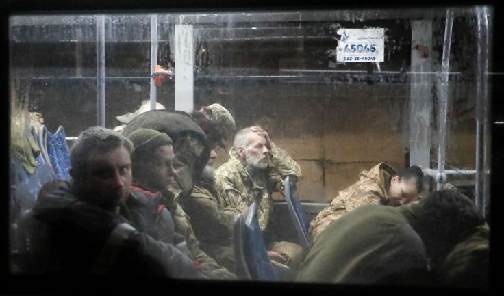 Service members of the Ukrainian armed forces, who surrendered at the besieged Azovstal steel mill in Mariupol in the course of Ukraine-Russia conflict, sit in a bus upon their arrival under escort of the pro-Russian military in the settlement of Olenivka