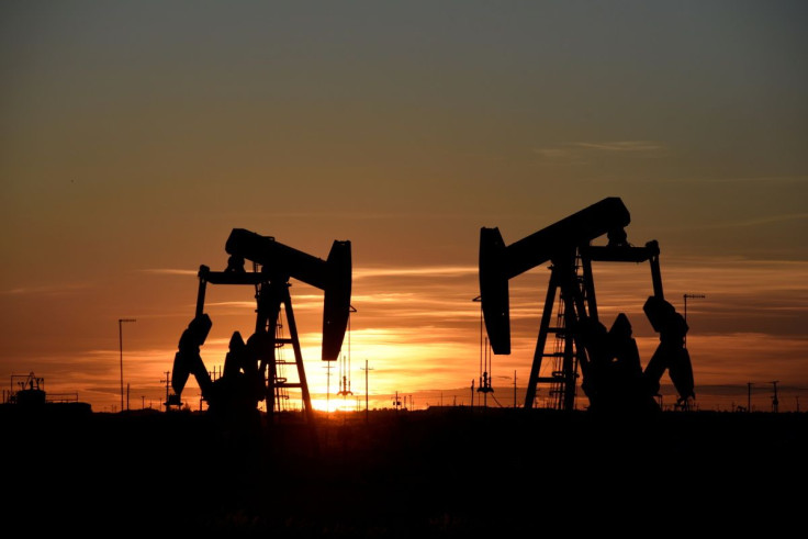 Pump jacks operate at sunset in an oil field in Midland, Texas U.S. August 22, 2018. 