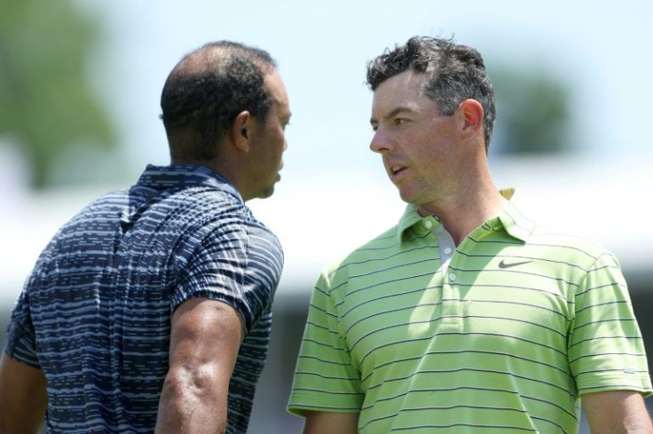 Rory McIlroy, right, fired a five-under par 65 to seize the lead at the PGA Championship on Thursday while Tiger Woods, left, struggled to a 74 in his latest comeback event after severe leg injuries