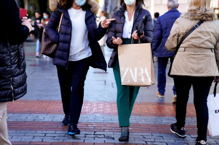 A shopper carries bags from Zara clothes store, part of the Spanish Inditex group, in Bilbao, Spain, November 30, 2021. 