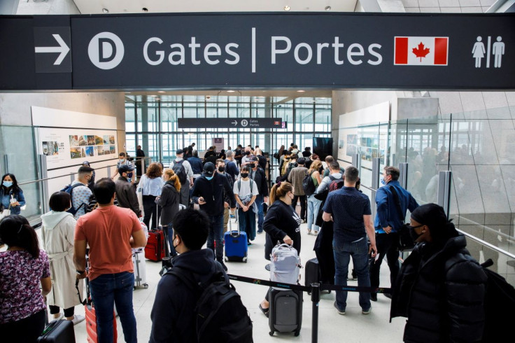 Travellers crowd the security queue in the departures lounge at the start of the Victoria Day holiday long weekend at Toronto Pearson International Airport in Mississauga, Ontario, Canada, May 20, 2022.  