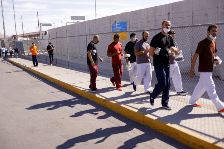 Cuban migrants, who were expelled from the U.S. and sent back to Mexico under Title 42, walk near the at the Lerdo Stanton International border bridge, in Ciudad Juarez, Mexico May 3, 2022. 