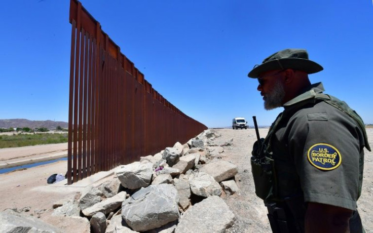 A US Border Patrol officer stands guard at a gap in the border wall separating Algodones, Mexico, from Yuma, Arizona, on May 16, 2022