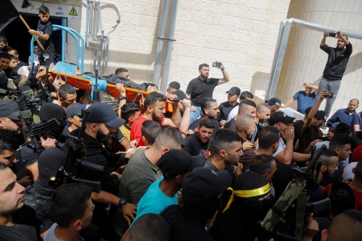 SENSITIVE MATERIAL. THIS IMAGE MAY OFFEND OR DISTURB Mourners carry the body of Palestinian militant Amjad Al Fayed, who was killed in clashes during an Israeli raid, during his funeral in Jenin in the Israeli-occupied West Bank May 21, 2022.