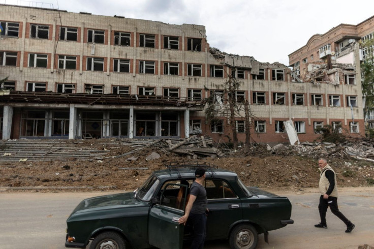 A local resident walks by a destroyed building after a rocket attack on a university campus, amid Russia's invasion, in Bakhmut, in the Donetsk region, Ukraine, May 21, 2022. 