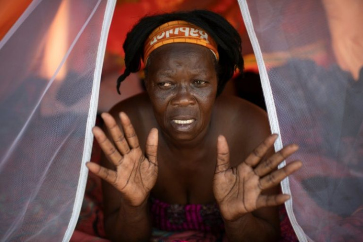 A Haitian migrant gestures from inside a tent at a shelter in the Mexican city of Reynosa on the border with the United States