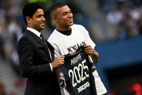 Kylian Mbappe poses with PSG president Nasser Al-Khelaifi after announcing he is staying at the club until 2025