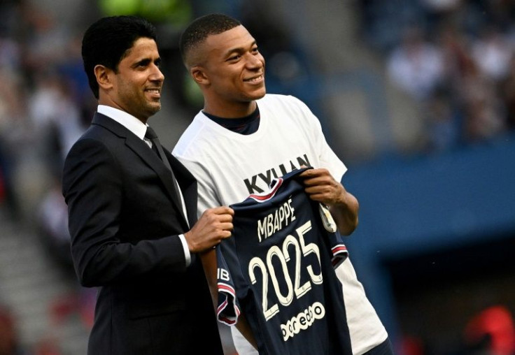 Kylian Mbappe poses with PSG president Nasser Al-Khelaifi after announcing he is staying at the club until 2025