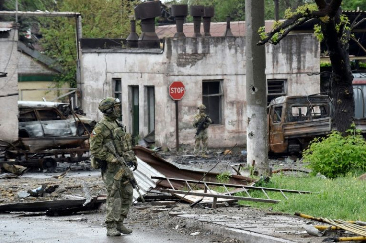 Russian servicemen patrol what is left of Mariupol