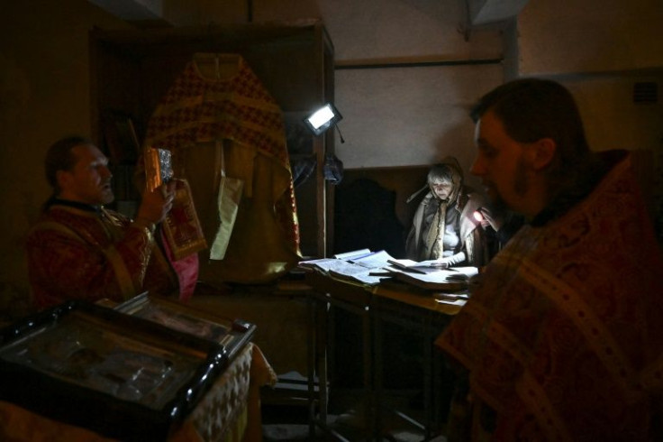 Orthodox priests have joined residents seeking shelter from the fighting in the Donbas, such as in this makeshift basement church at Lysychansk