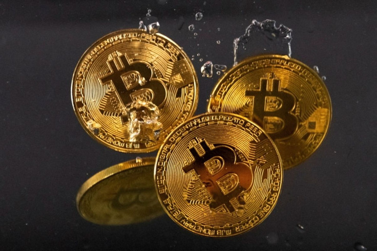 Souvenir tokens representing cryptocurrency Bitcoin plunge into water in this illustration taken May 17, 2022. 