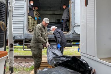 Ritual workers load bodies of killed Russian soldiers to a refrigerated rail car, as Russia's attack on Ukraine continues, at a compound of a morgue in Kharkiv, Ukraine May 22, 2022.  