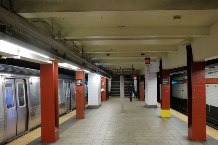 A commuter walks through the 42nd Street Bryant Park subway station during what is typically rush hour, but is largely empty due to the coronavirus disease (COVID-19) forcing large numbers of people to stay home in Manhattan, New York City, U.S., March 18