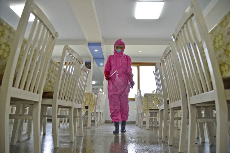 A worker disinfects a dining room at a sanitary supplies factory, amid growing fears over the spread of the coronavirus disease (COVID-19), in Pyongyang, North Korea, in this photo taken on May 16, 2022 and released by Kyodo on May 17, 2022. Mandatory cre