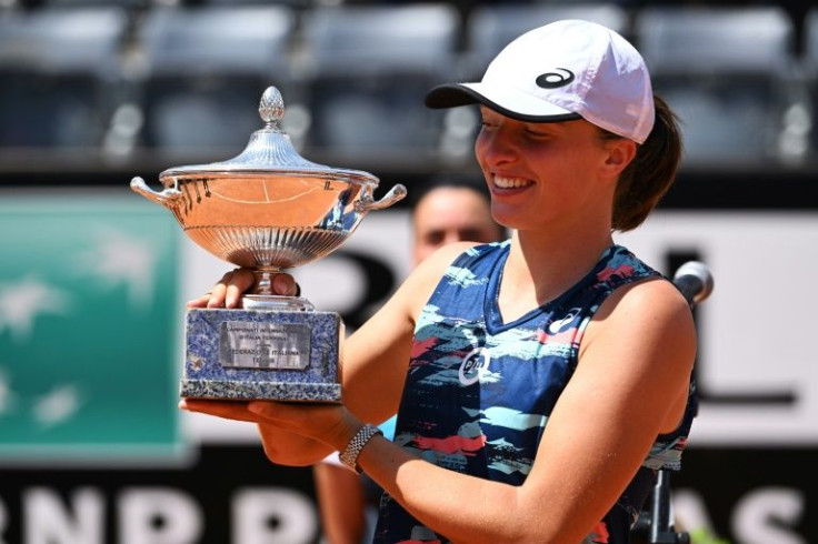 Iga Swiatek poses with her Italian Open trophy