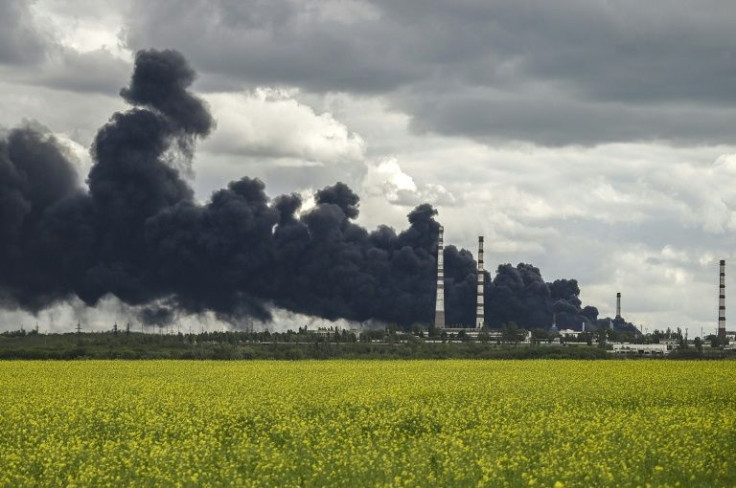 Smoke rises from an oil refinery after an attack outside the city of Lysychansâk in Ukraine's Donbas region