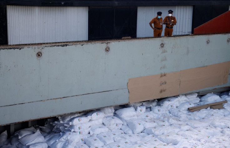 Members of security personnel stand on a cargo ship carrying essential supplies of rice, milk and some critically needed medicines from India, amid Sri Lanka's economic crisis, at a port in Colombo, Sri Lanka, May 22, 2022. Picture taken on May 22, 2022.