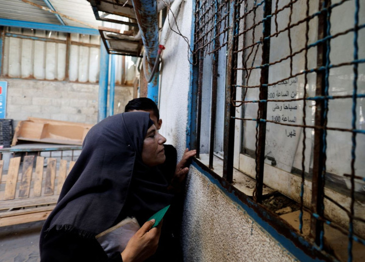 A Palestinian woman waits to receive food supplies at an aid distribution centre run by United Nations Relief and Works Agency (UNRWA), at Beach refugee camp in Gaza City May 22, 2022.