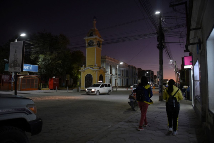 People walk in a small town near the Salar de Uyuni, a vast white salt flat at the center of a global resource race for the battery metal lithium, in Uyuni, Bolivia March 28, 2022. 