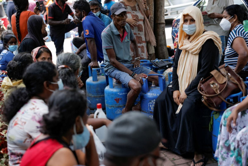 People wait in a line to buy domestic gas tanks near a distributor, amid the country's economic crisis, in Colombo, Sri Lanka, May 23, 2022. 