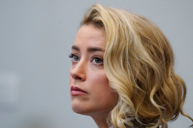 Actor Amber Heard watches the jury arrive in the courtroom during actor and her ex-husband Johnny Depp's defamation case against her, at the Fairfax County Circuit Courthouse in Fairfax, U.S., May 23, 2022.  Steve Helber/Pool via REUTERS