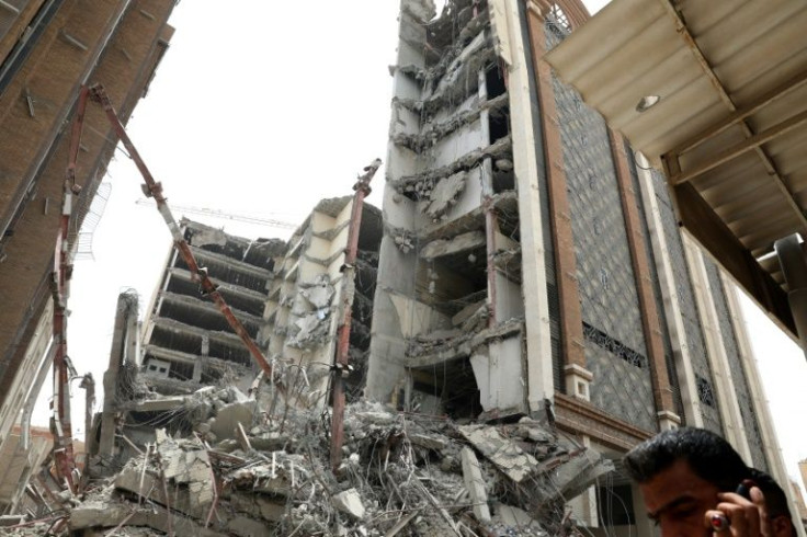 Iranians gather at the site where a high-rise building collapsed in the southwestern city of Abadan on May 23