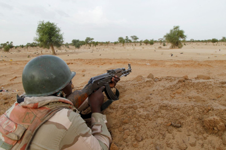 A Niger soldier guards with his weapon pointed towards the border with neighbouring Nigeria, near the town of Diffa, Niger, June 21, 2016. Picture taken June 21, 2016. 